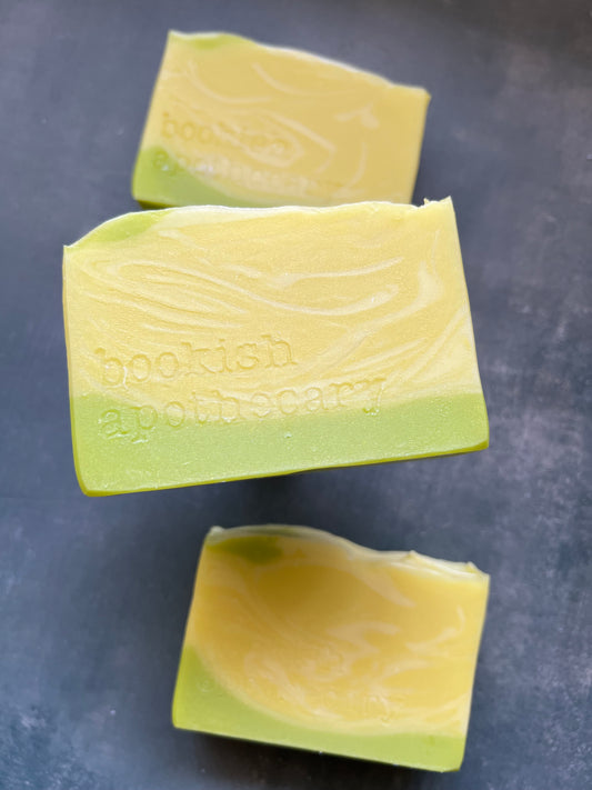 Three bars of green soap on a dark surface