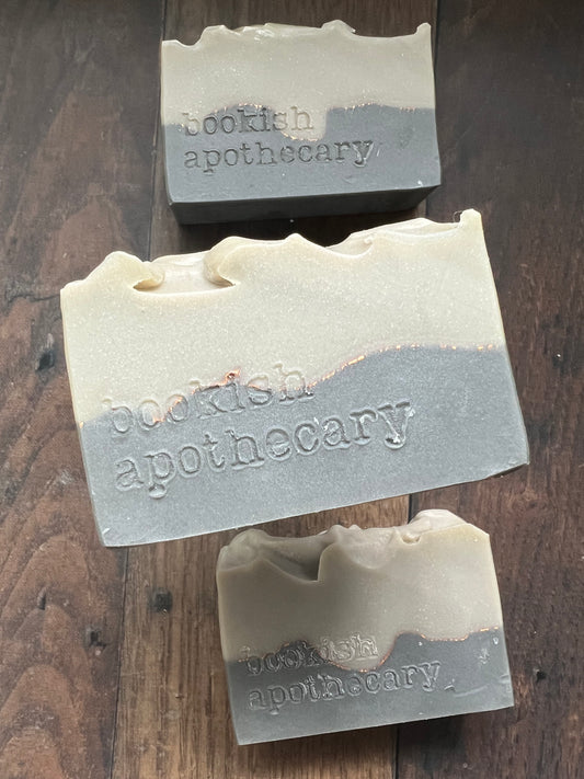Three bars of soap from 'bookish apothecary' on a wooden surface