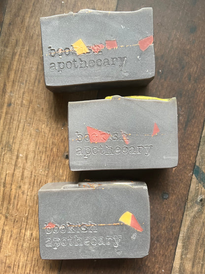 Three soap bars from Bookish apothecary on a wooden surface