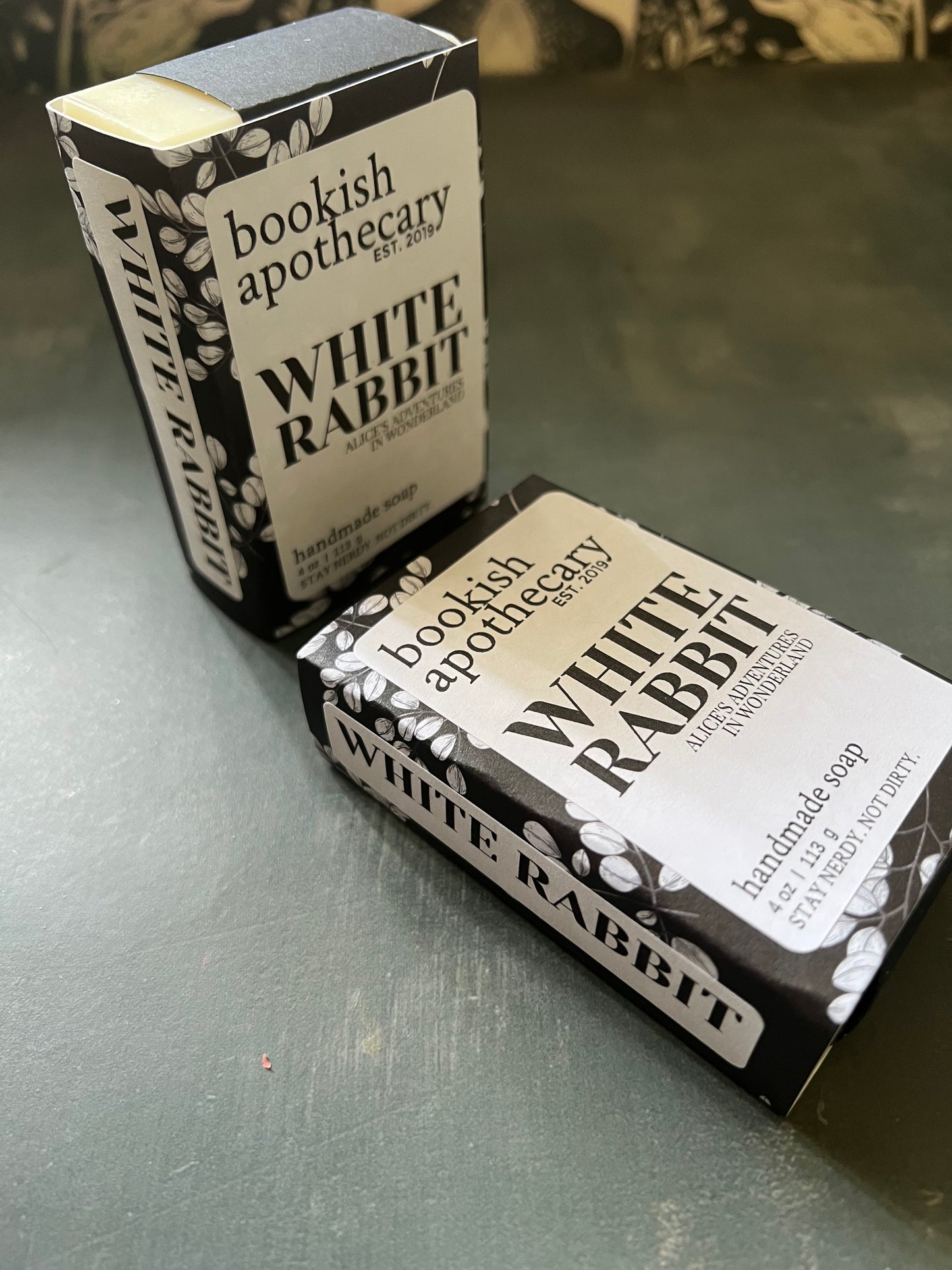 Two soap bars with 'White Rabbit' branding on a gray surface