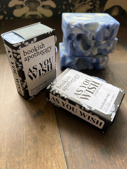 Five bars of blue and white swirled soaps wrapped to resemble books with bookish apothecary branding
