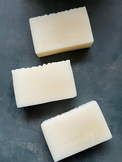 Three bars of soap on a dark gray surface