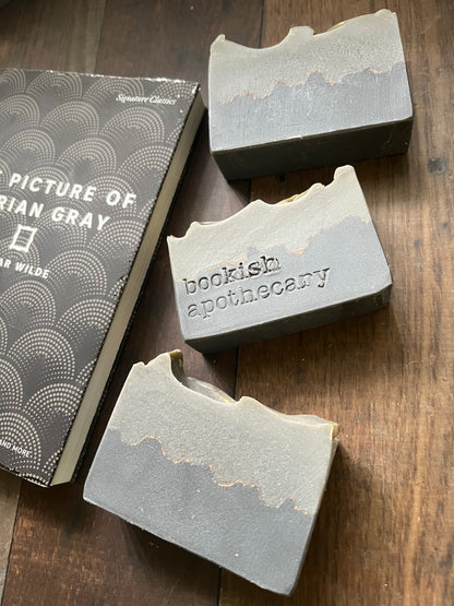 Three bars of soap from 'bookish apothecary' on a wooden surface