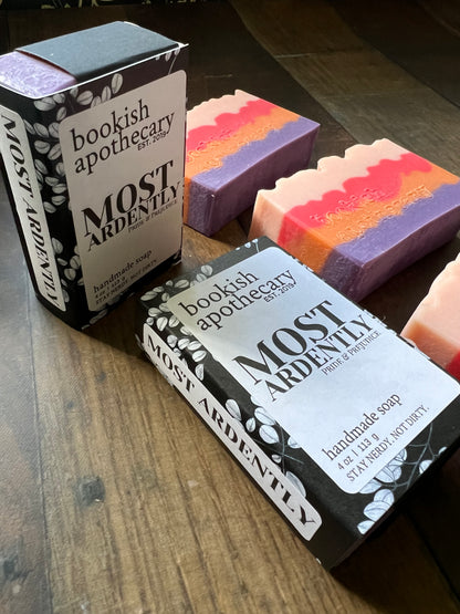 Three bars of soap wrapped to look like books with bookish apothecary branding.