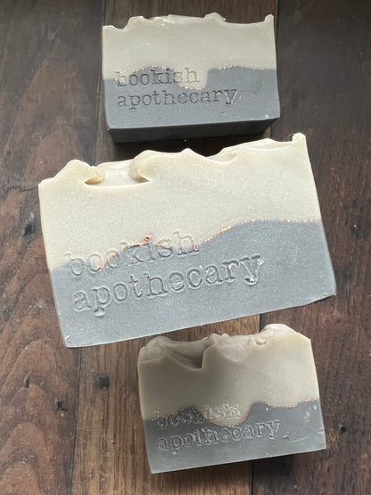 Three bars of soap from 'bookish apothecary' on a wooden surface