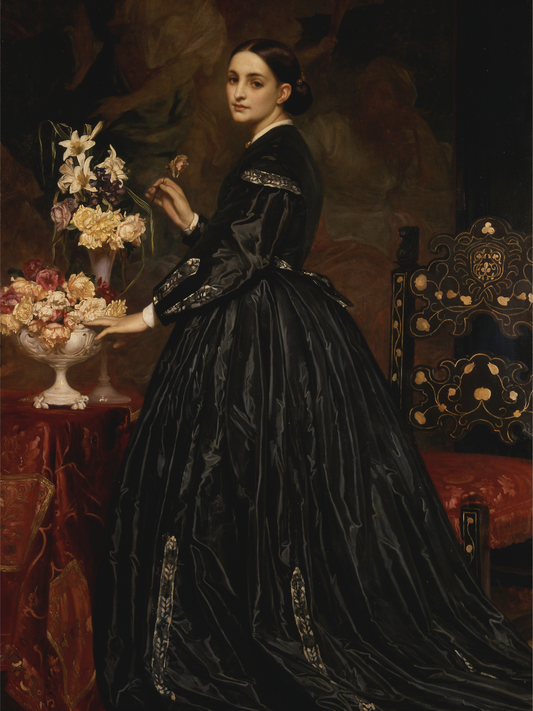 Woman in a black Victorian dress holding flowers in a classical setting